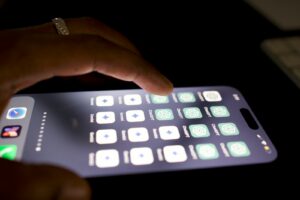 a close up of a person touching a cell phone